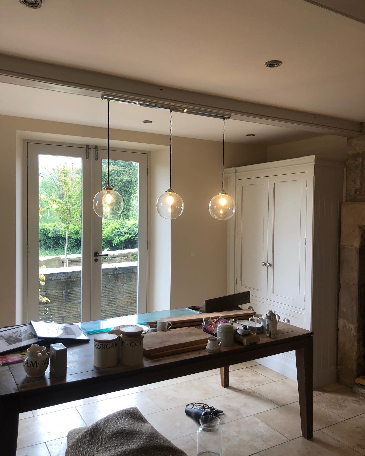 Kitchen diner with pendant lights and French doors, mid job with sheets down